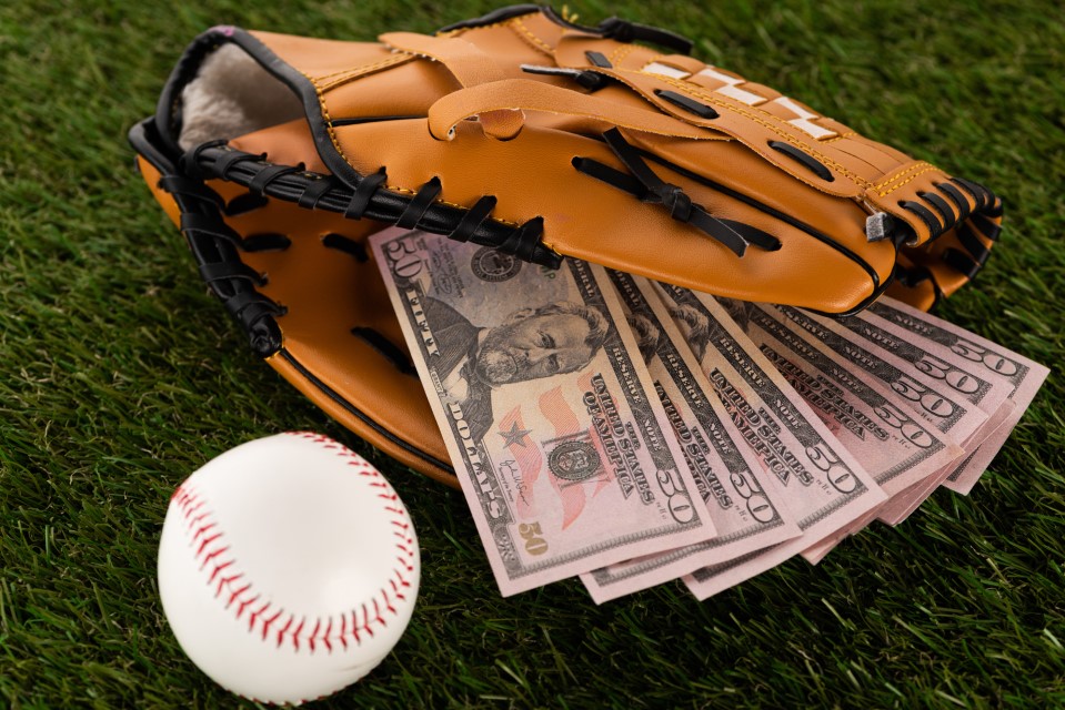 dollar-banknotes-in-baseball-glove-near-ball-online-sports-betting-singapore-malaysia